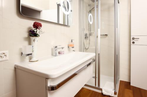 a bathroom with a sink and a shower at Al Ciani Balcony Suite in Lugano