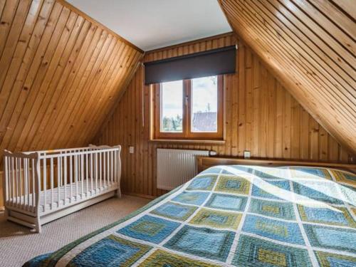a bedroom with a large bed and a window at Apartament u Tomka in Zakopane