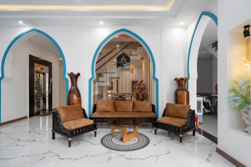 a lobby with two chairs and a couch and a mirror at Phuong Dong Hotel and Apartment in Quy Nhon