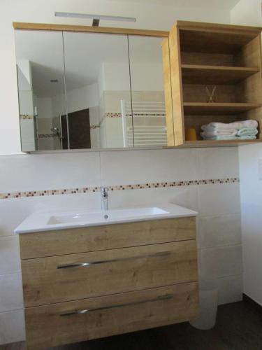 a bathroom with a sink and a mirror at Frühstückspension Sunnhäusl in Sankt Veit im Pongau