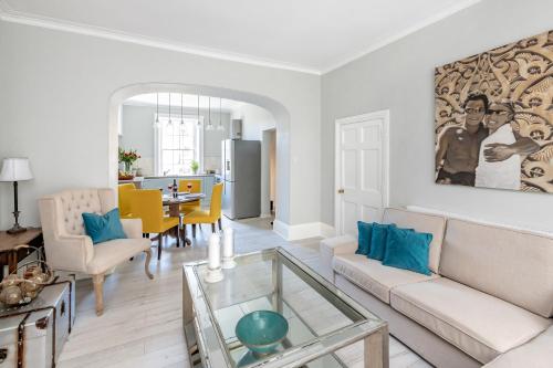 a living room with a couch and a table at Gorgeous Garden Apartment in Bath