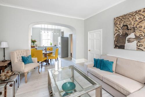a living room with a couch and a table at Gorgeous Garden Apartment in Bath
