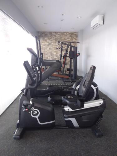 a gym with cardio equipment in a room at AJ Sundiva Tower w balcony in Cebu City