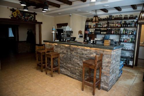 a bar with stools in a room with a brick wall at Holiday stay Nika in Busk