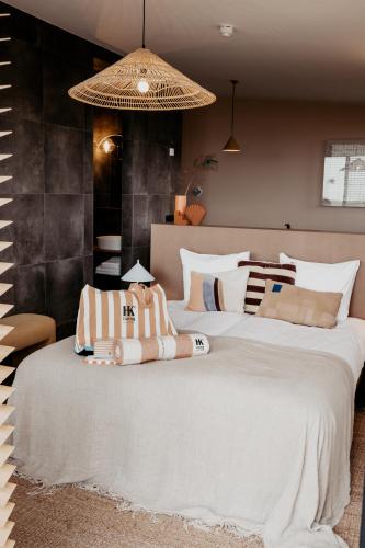 a bedroom with two large beds with white sheets at Strandhotel Zoomers in Castricum