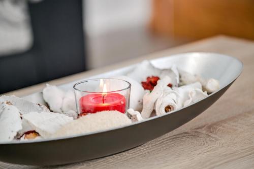 a candle is sitting in a bowl with food at 2a Francesca in Vecindario