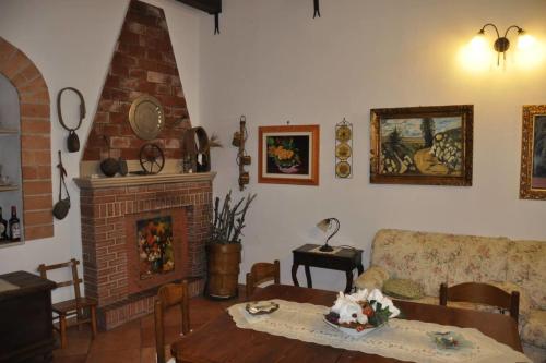 a living room with a table and a fireplace at Basilicata Host to Host - Storia, mare e relax - la casa che cercate - in Pisticci