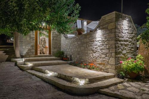 a stone retaining wall with stairs and lights at Exclusive Crete Villa Villa Myrrini 3 Bedroom Private Pool Rethymnon in Astérion