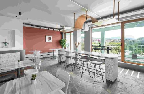 a rendering of a restaurant with tables and stools at Zeus is Loose Hostel in Thessaloniki