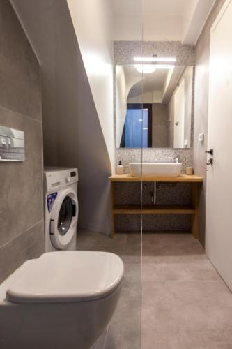 a bathroom with a toilet and a sink at Villa Naya in Yénion
