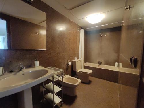 a bathroom with a sink and a toilet at Sunny apartment with fantastic terrace views! in Valencia