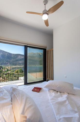 a bedroom with a bed and a large window at Villa Naya in Yénion
