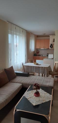 a living room with a couch and a table at Apartments Sea Sounds in Pomorie