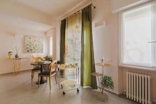 a living room with a table and a window at La Maison Di Carla in Ancona