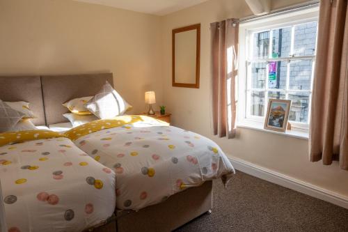 a bedroom with a bed with a pillow and a window at Highgate View Apartment in Kendal