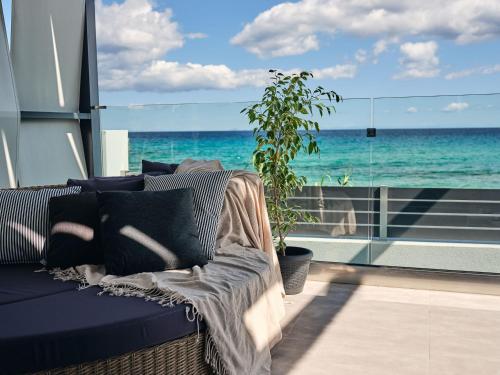 a couch in a room with a view of the ocean at Blue View Villa - Coastal Elegance with Swim Spa, by ZanteWize in Alikanas