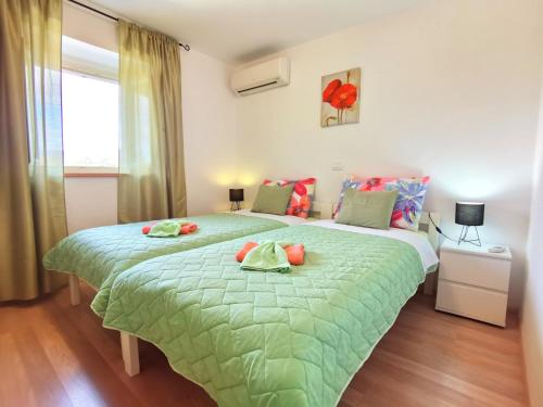 A bed or beds in a room at Jasmina Apartment