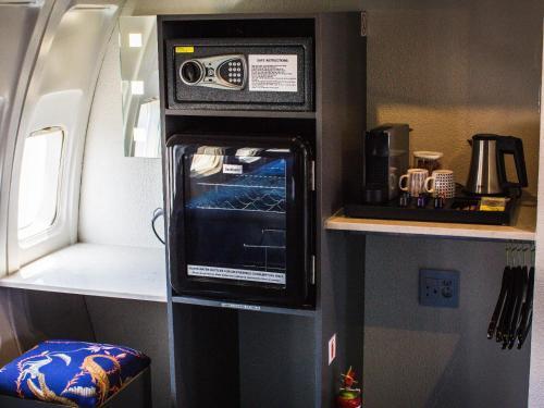 a microwave oven sitting on a wall in a room at Aerotel in Hoedspruit