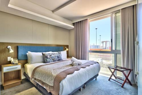 a bedroom with a bed and a large window at Harbour Bridge 13A in Cape Town