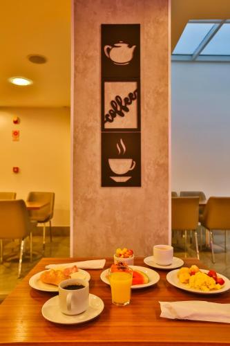 a table with plates of food on top of it at ibis Copacabana Posto 2 in Rio de Janeiro
