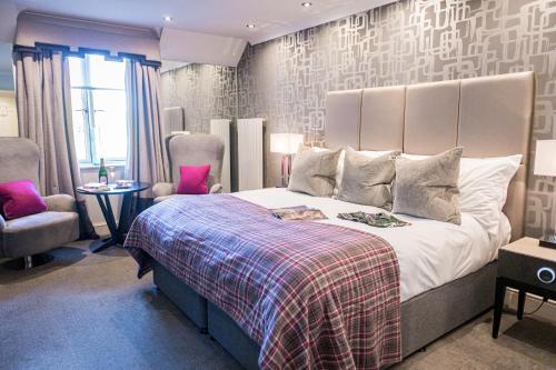 A bed or beds in a room at Rowhill Grange Hotel & Utopia Spa 