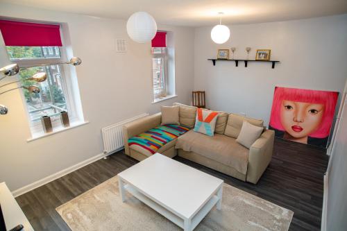 a living room with a couch and a table at Two Bedroom Duplex in Angel HIgh Street in London