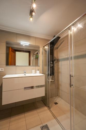 a bathroom with a sink and a shower at Ocean Breeze in Caniço