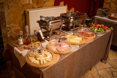 a buffet table with food on top of it at Vila Eden Boutique Hotel in Korçë