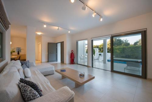 a living room with a white couch and a table at Villa Gonia in Gonia