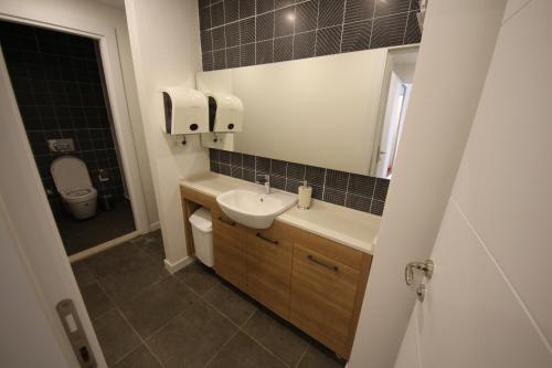 a bathroom with a sink and a toilet at SPİLOS GÜMÜLDÜR HOTEL in İzmir