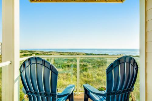 two blue chairs sitting on a porch looking out at the ocean at Ocean Avenue Condos in Westport