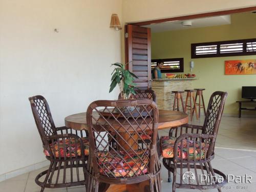 a dining area with chairs, tables and chairs at Pipa Park in Pipa