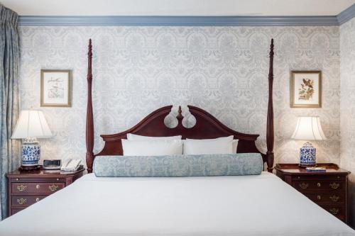 a bedroom with a large bed and two night stands at The Farmington Inn and Suites in Farmington