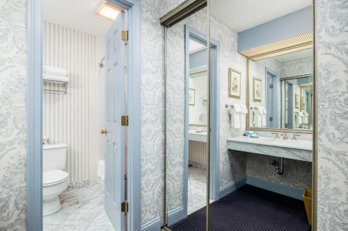 a bathroom with a toilet and a sink at The Farmington Inn and Suites in Farmington