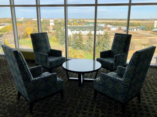 a room with chairs and a table and a large window at Holiday Inn Express & Suites - Saskatoon East - University by IHG in Saskatoon