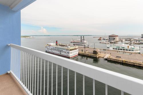 a balcony with a view of a harbor with boats at Holiday Inn Kingston - Waterfront by IHG in Kingston