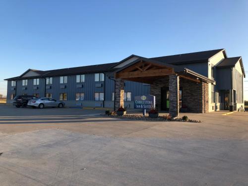 a large building with a parking lot in front of it at Cobblestone Inn & Suites - Trenton in Trenton