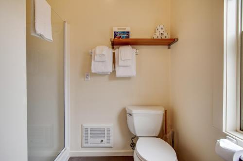 a bathroom with a toilet and a shower and towels at Headlands View in Mendocino