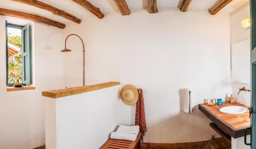 a bathroom with a sink and a wooden counter at Casa Barichara Boutique in Barichara