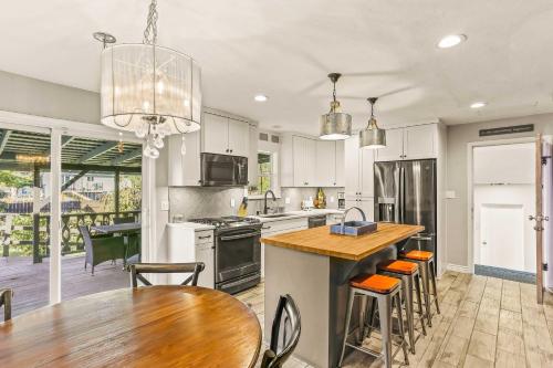 a kitchen with white cabinets and a table and chairs at Spacious Family Home with Garage Game Room and Office! in Boise