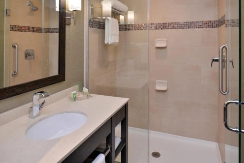 a bathroom with a sink and a shower at Crowne Plaza Shenandoah - The Woodlands Area by IHG in The Woodlands