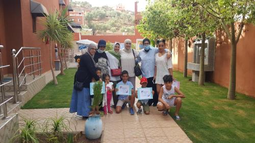 a group of women and children posing for a picture at Hôtel Ajil Cascades D'ouzoud in Ouzoud