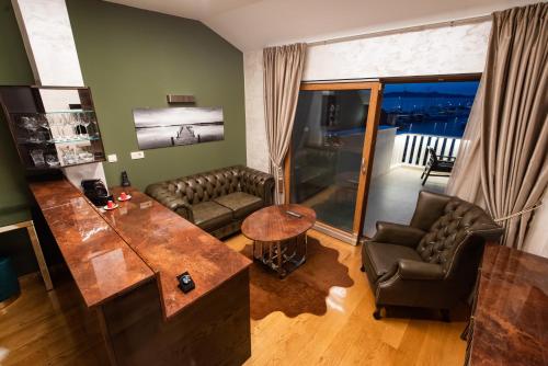 a living room with a couch and a table at Suites Kod Guste in Sukošan