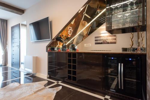 a kitchen with a black counter and a tv at Suites Kod Guste in Sukošan