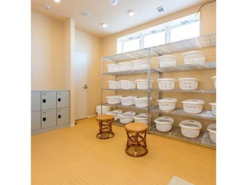 een kamer met planken gevuld met witte gerechten bij OGAL INN - Vacation STAY 01889v in Akaishi