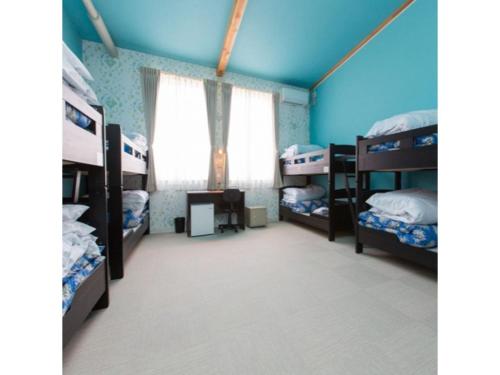 a bedroom with bunk beds and a window at OGAL INN - Vacation STAY 01883v in Akaishi