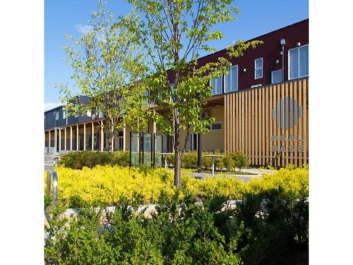 a building with a tree in the middle of a garden at OGAL INN - Vacation STAY 01883v in Akaishi
