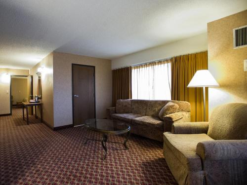 a living room filled with furniture and a couch at Ramada by Wyndham Topeka Downtown Hotel & Convention Center in Topeka
