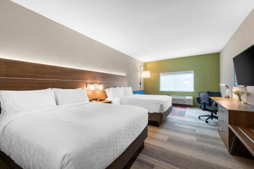 a hotel room with two beds and a desk at Holiday Inn Express & Suites Alachua - Gainesville Area by IHG in Alachua