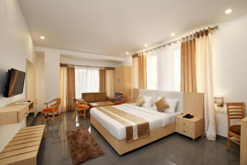 a hotel room with a large bed and a desk at De Lagom Comforts, Anjuna Beach - A boutique hotel in Anjuna